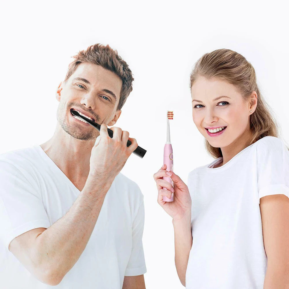 Man and woman using electric toothbrushes on a white background